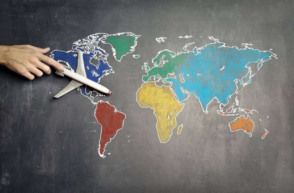Person With Toy Plane On The World Map Colorized